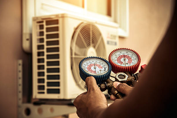 Professional Air Conditioning Service technician working in Hudson, CO